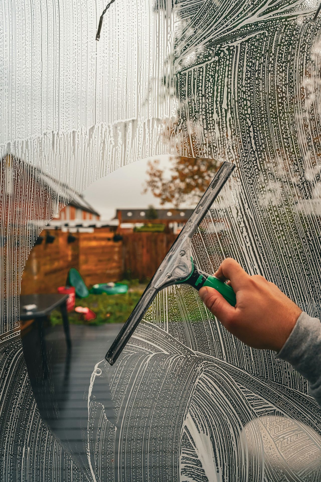 A person is drawing a picture on a window